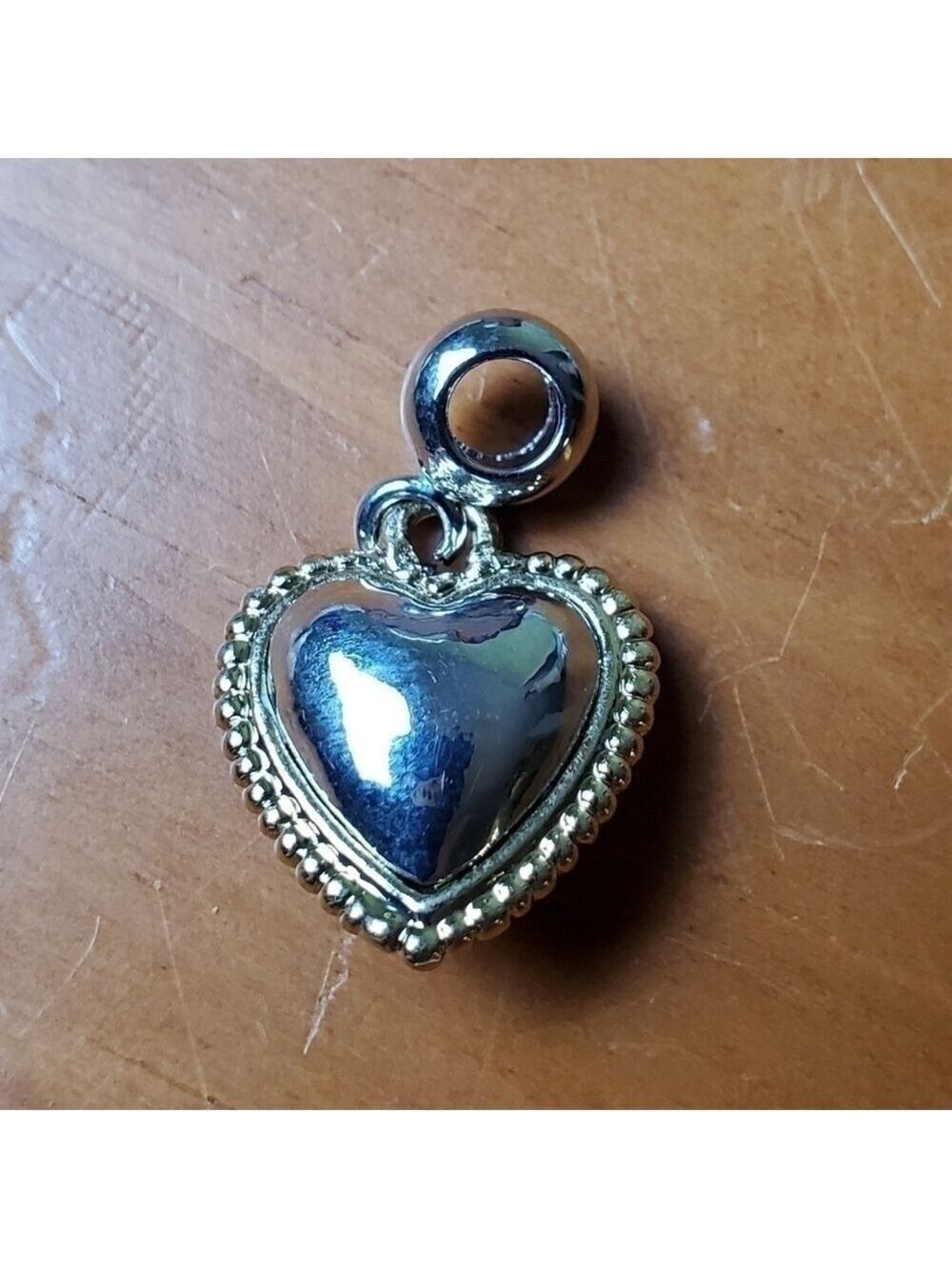 NWOT charm, silver colored heart with gold colored trim